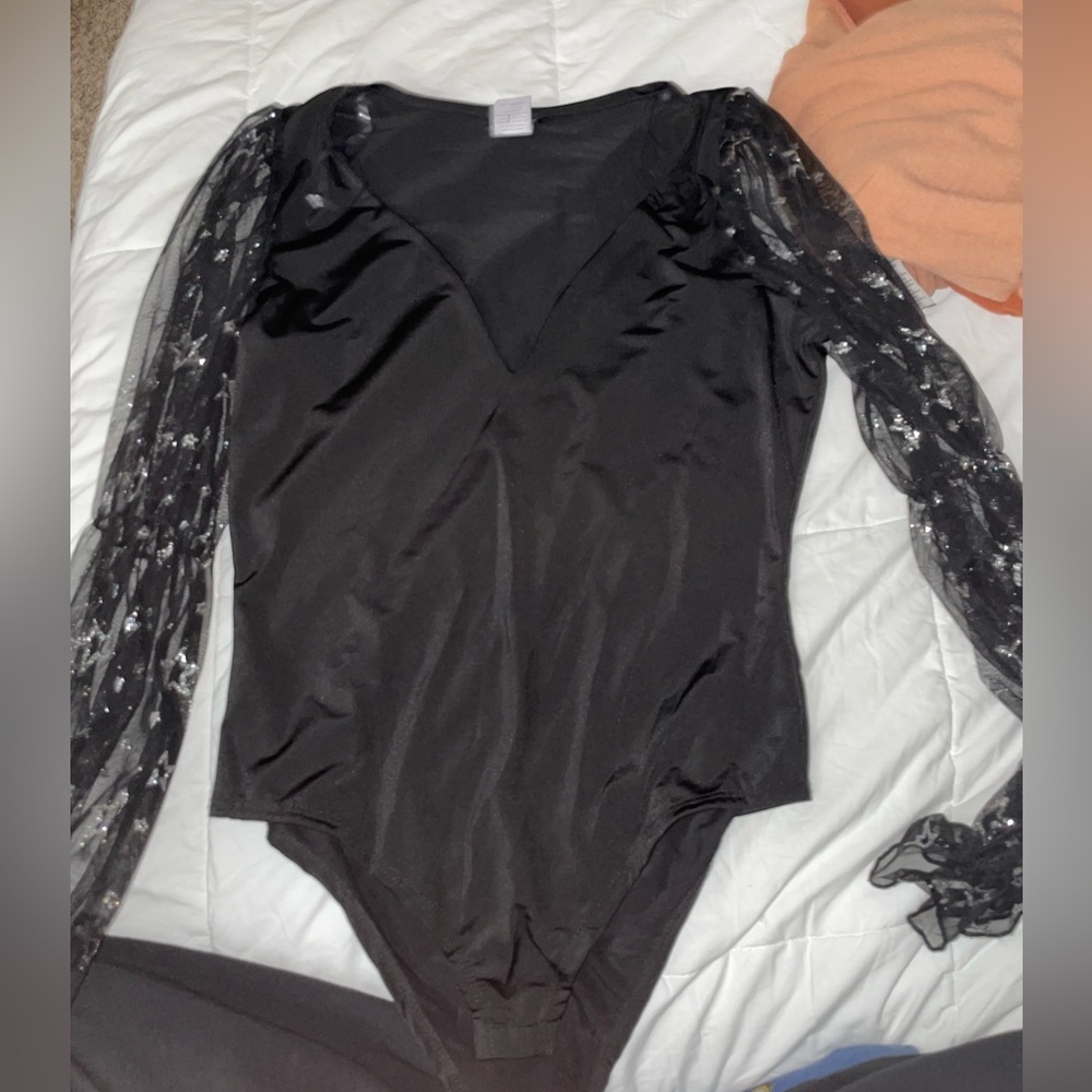 black body suit with sheer sleeves